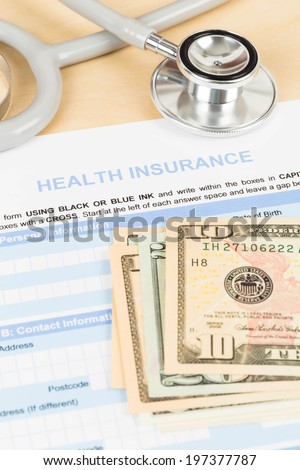 Health insurance application form with banknote and stethoscope concept for life planning