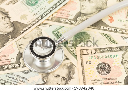 Stethoscope on dollar banknote concept financial health check