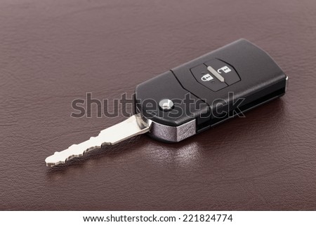 Modern remote car key on brown leather