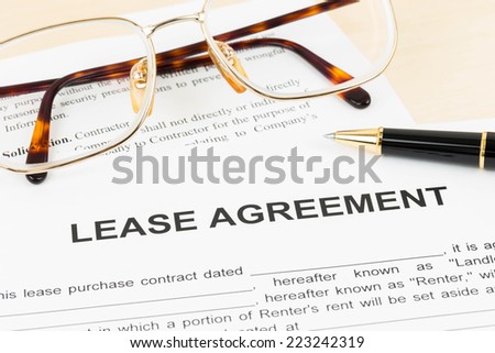 Lease agreement document with glasses and pen