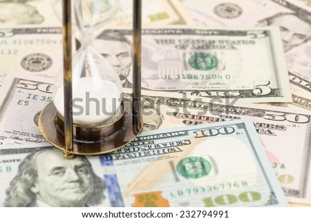 Hourglass and dollar banknote concept for time value