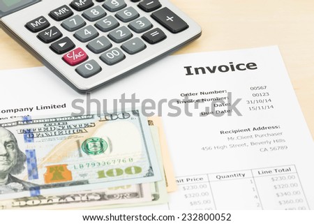 Invoice with calculator and dollar banknote