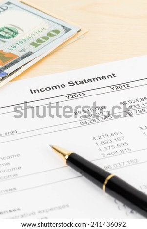 Income statement financial report with pen, and banknote