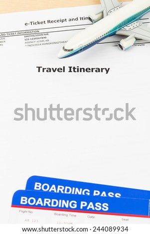 Travel itinerary with copy space, plane model, and boarding pass