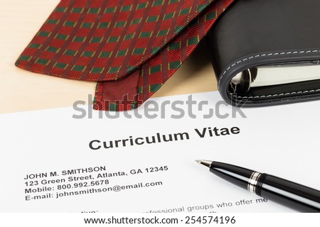 Curriculum vitae or CV with pen, organizer and neck tie; document is mock-up