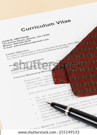 Curriculum vitae or CV with pen, and neck tie; concept job applying; document is mock-up