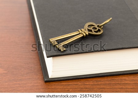 Antique key on book cover