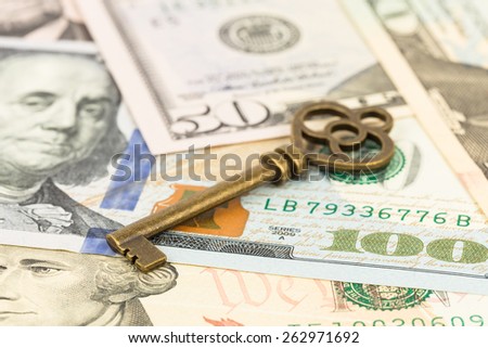 Antique key on dollar banknote concept for success