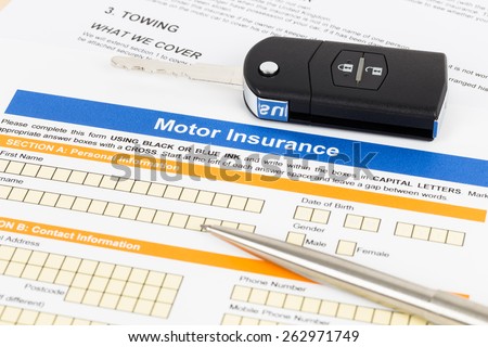 Motor or car insurance application with pen and car key; document is mock-up