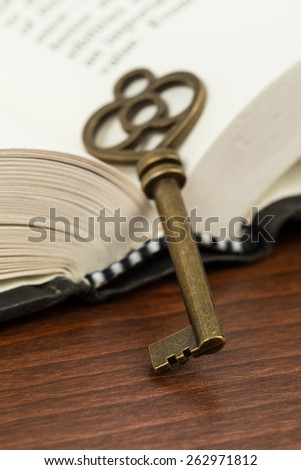 Antique key on opened book page