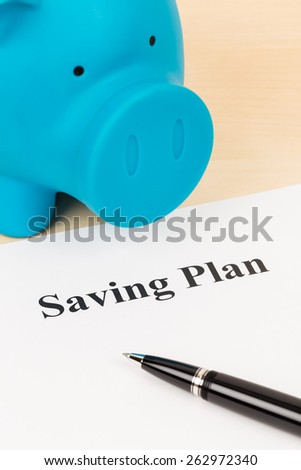 Saving plan with pen and piggy bank