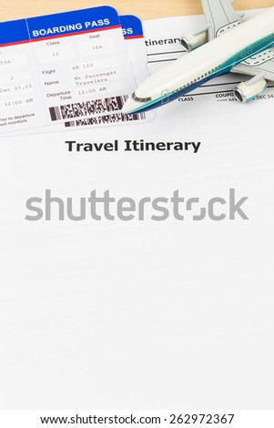 Travel itinerary with copy space, plane model, and boarding pass;  document and boarding pass are mock-up