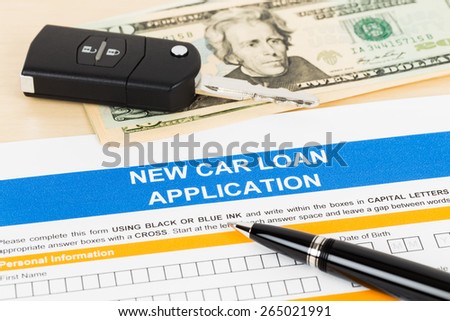 Car loan application with car key and dollar banknote; form is mock-up