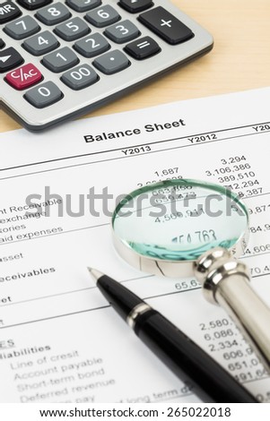 Income statement with pen, magnifier, and calculator; statement is mock-up