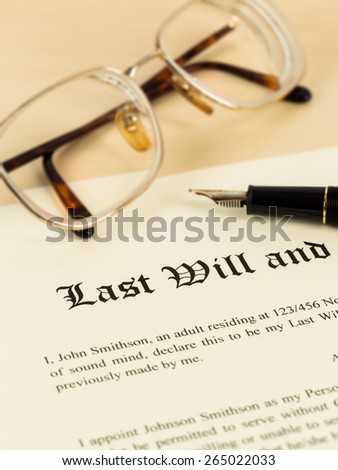 Last will on cream color paper with glasses and pen; document is mock-up