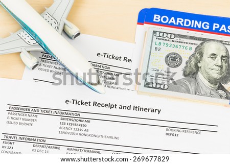 E-ticket with plane model, banknote, and boarding pass; these documents are mock-up