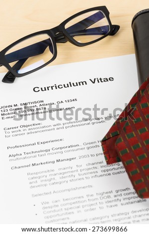 Curriculum vitae or CV with glasses, organizer and neck tie; concept job applying