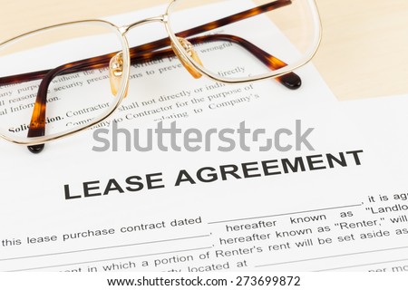 Lease agreement with glasses; document and information are mock-up