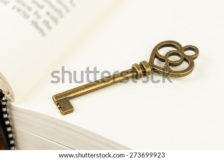 Antique key on book page