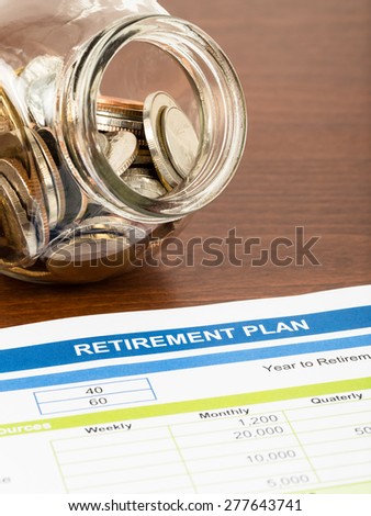 Retirement plan with coin jar; document is mock-up