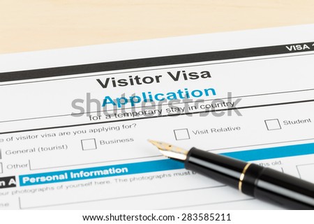 Visa application form with pen; form is mock-up