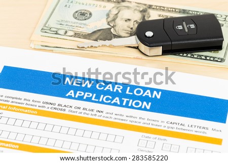 Car loan application with car key and dollar banknote; form is mock-up