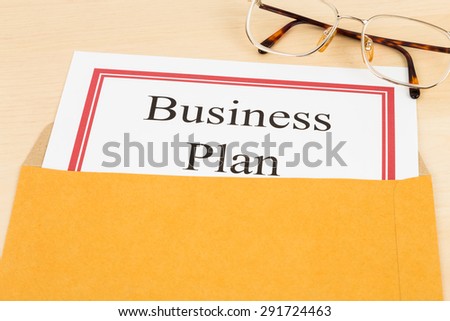 Business plan in  envelope with glasses