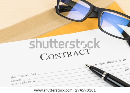 Business contract document with pen and glasses on envelope
