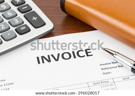 Invoice with pen, calculator, and organizer; document is mock-up