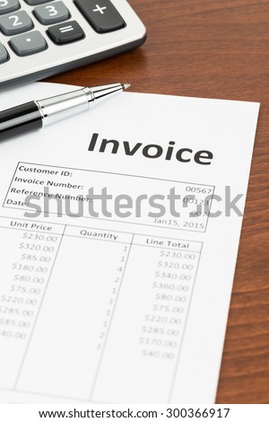 Invoice with pen and calculator; invoice is mock-up