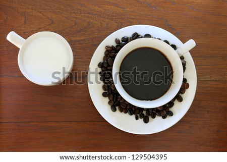 coffee cup with Coffee Beans and milk on grunge wood