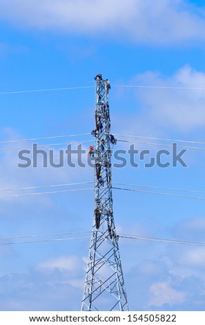 electrician worker at climbing work on high voltage post