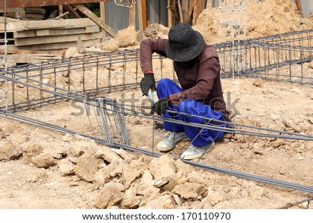 worker prepare steel rod for construction job