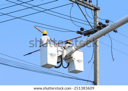 electrician working on electric pole