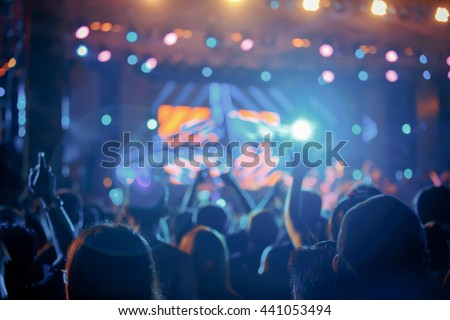 Crowd in front of concert stage blurred