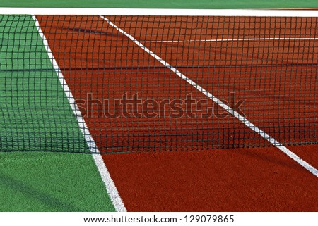 Sports field with synthetic turf, markings and netting used in tennis.Detail.