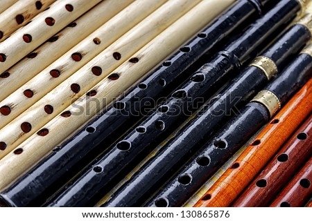 Whistles made from different types of wood and colored.