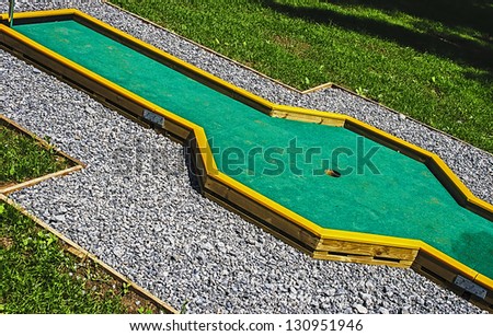 Small golf course built for children in a recreational space.