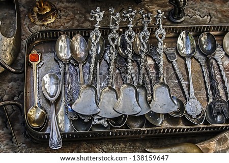 Old silver teaspoons are in a kit