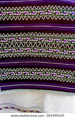 Material with romanian traditional embroidery, used to women clothes.
