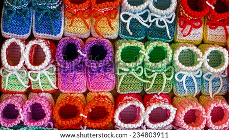 Knitted booties for newborns, from colored wool and exposed to sale.