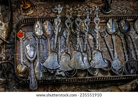 Old silver teaspoons are in a kit. Image digitally manipulated in the form of old photos.