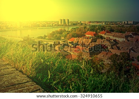 Cityscape in Novi Sad, Serbia. Old and new, seen from the Petrovaradin fortress height in sunset light.Image digitally manipulated.