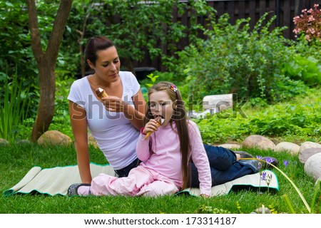 Mother and daughter eating ice-cream