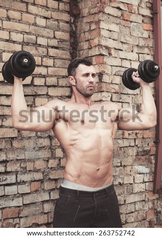 Young Muscle man in sport training outdoors