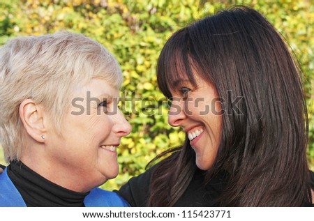 Beautiful portrait of senior mother and daughter laughing