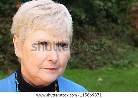 Portrait of a beautiful senior lady looking sad