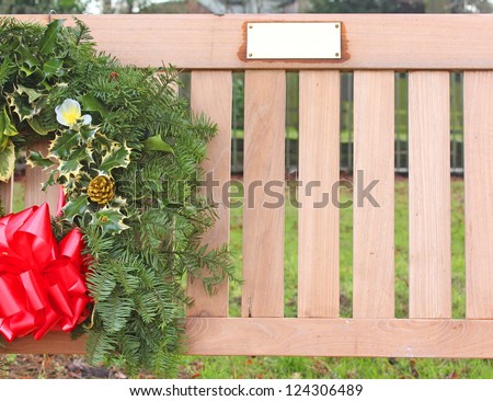 Memorial bench with wreath and name plaque