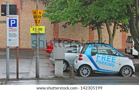 BIRMINGHAM, UNITED KINGDOM - 14 JUNE: One of the new 250 car2go cars in Birmingham taking advantage of it\'s free parking in and around the city, 14 June 2013, Birmingham