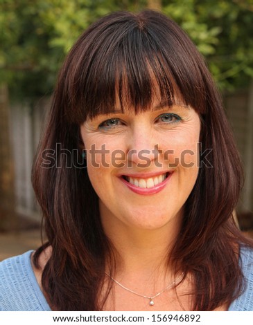 Beautiful outdoor portrait of a stunning middle-aged lady